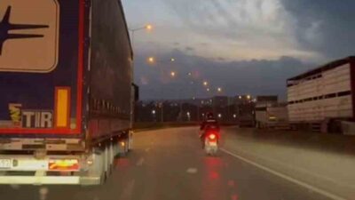 Hatay'da etkili olan fırtına, motosiklet sürücüsüne zorluk yaşatırken, bir tır